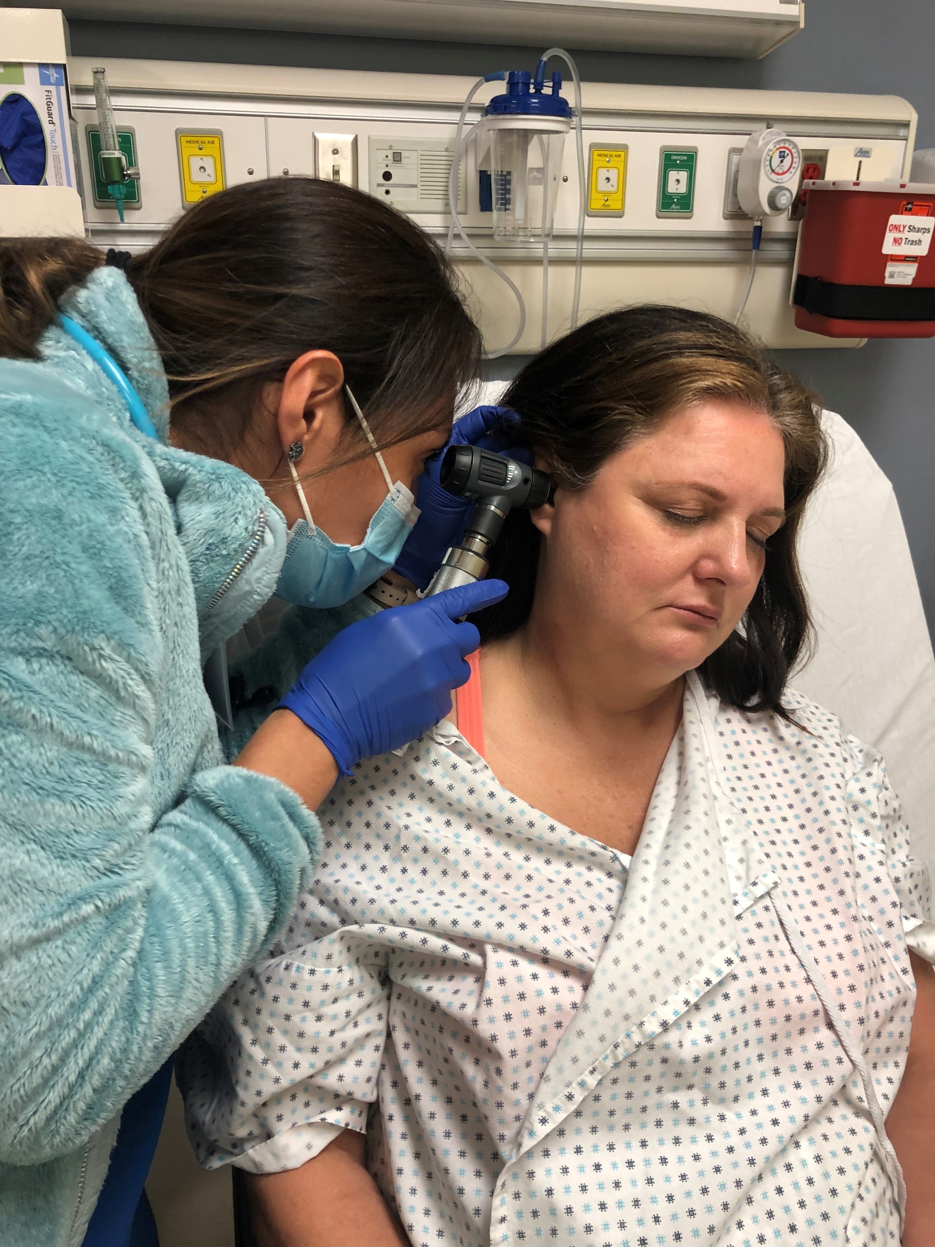 Nurse examines patient for injuries